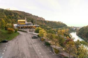 a building on the side of a road next to a river at Guest Accommodation Primula in Nova Gorica