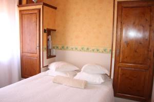 a bed with two pillows and a towel on it at La Marjolaine in Juan-les-Pins
