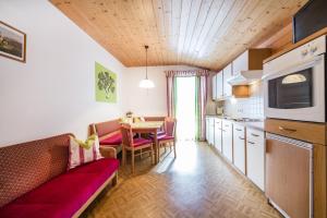 a kitchen with a couch and a table in a room at Scharfetthof in Flachau