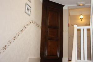 a staircase with a wooden door next to a stair case at La Marjolaine in Juan-les-Pins