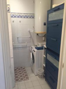 a bathroom with a washing machine and a blue cabinet at Clos des Templiers in Saint-Rémy-de-Provence +18 photos