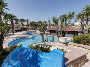 a swimming pool with a blue slide in a resort at Apartamento Rey-Piscina in Denia