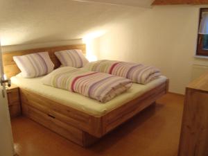 a bed with two pillows on it in a room at Ferienhaus Brütting in Pottenstein