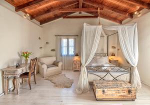 a bedroom with a bed and a desk and a chair at Verekinthos Villas in Yerolákkos