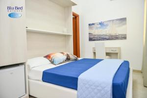 a bedroom with a blue and white bed in a room at Blu Bed Salento in Torre Lapillo