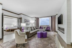 a living room with a couch and a bed at Harrah's Resort Atlantic City Hotel & Casino in Atlantic City