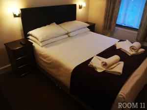 a hotel room with a bed with towels on it at Westgate Hotel in Oxford