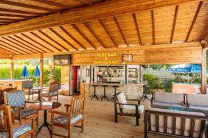 a patio with tables and chairs and a bar at Citrus Tree Gardens in Kyrenia