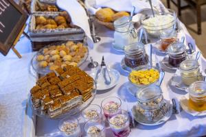 a table with a buffet of food and desserts at Optima Cherkasy Hotel in Cherkasy
