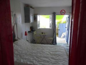 een slaapkamer met een bed en een deur naar een patio bij CASA PENTONE in Cervione