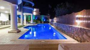 a swimming pool at night with lights on it at Luxury Suite by the pool in Eilat