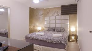 a bedroom with a large bed with two pillows at Luxury Suite by the pool in Eilat +33 photos