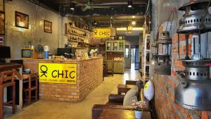 a restaurant with a sign that reads x chico on the wall at OK CHIC PHUKET HOSTEL in Phuket