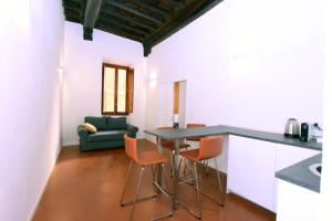 a kitchen with a table and chairs and a couch at Monte Giordano Flats in Rome