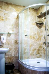 a bathroom with a tub, toilet and shower stall at Mini-Hotel Coral Family in Mostovskoy