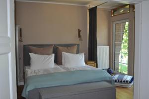 a bedroom with a large bed with white pillows at Strandvilla Waldhaus in Boltenhagen