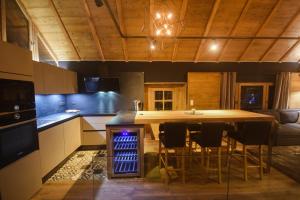 オロンにあるLa Grange d'Aur - Place d'Auronの大きな木製のテーブルと椅子のあるキッチン