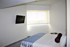 TV a/nebo společenská místnost v ubytování Hotel Plaza Kokai Cancún