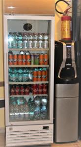 an open refrigerator with drinks in it next to a refrigerator at Hotel Eurorooms in Rome