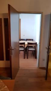 a door leading into a dining room with a table at Appartmenthaus am Moosweg in Seefeld in Tirol