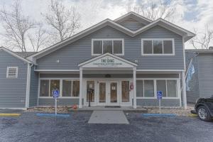 a gray house with a sign in front of it at Stony Court by Coolvacay in Basye