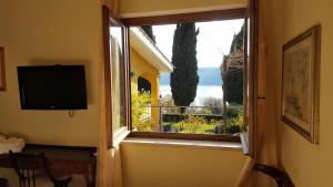 a window in a room with a view of a church at Il Nido del Falco in Castel Gandolfo