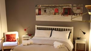 a bedroom with a bed and a picture of a building at Casa Barbero Charme B&B in Catania