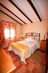 a bedroom with a large bed and a window at Casa Rural Cortijos San Jose in Iznájar +89 photos