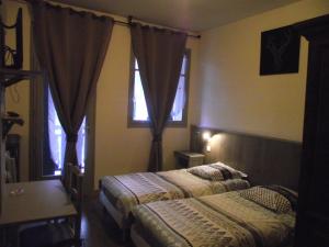 Postel nebo postele na pokoji v ubytování Hotel Valérie