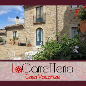 a stone house with a table and chairs in front of it at La Carretteria Guest house in Mistretta