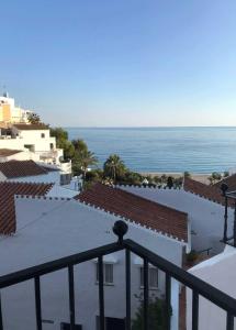 a view of the ocean from the balcony of a building at Capistrano Playa 307 in Nerja