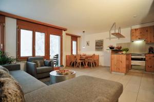 a living room with a couch and a table at Lakeside - 3.5 Zimmer Ferienwohnung am Laaxersee in Laax +43 photos
