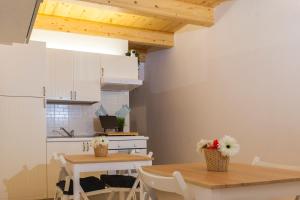 a kitchen and dining room with a table and chairs at B&b Oltre l'Arco in Molfetta