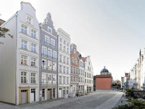 a row of white buildings on a street at VIU Old Town Balcony in Gdańsk