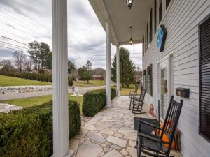 a porch of a house with chairs on it at Terrell House B&B in Burnsville