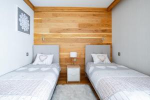 Posteľ alebo postele v izbe v ubytovaní Apartament Skrzyczne