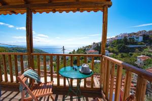 a table on a deck with a view of the water at Asteri Apartments in Alonnisos