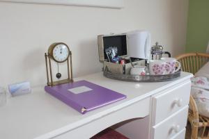 a white desk with a clock on top of it at Cairnview Bed and Breakfast in Larne