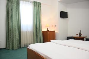 Postel nebo postele na pokoji v ubytování Hotel Sir Orhideea