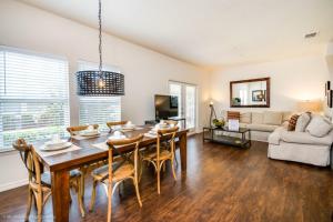 a dining room and living room with a table and chairs at Lucaya Village Resort Townhome Unit 14 Townhouse in Orlando