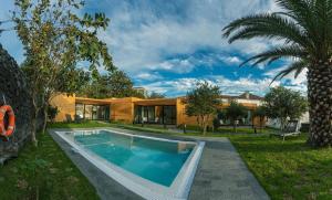 a swimming pool in the backyard of a house at Quinta do Passo in Ribeira Grande