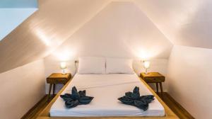 Ένα ή περισσότερα κρεβάτια σε δωμάτιο στο Garden loft 90sqm in the heart of El Nido- 2 bedrooms
