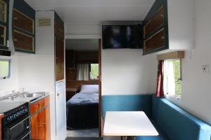 a small kitchen with a sink and a bed at Riverton Holiday Park in Riverton