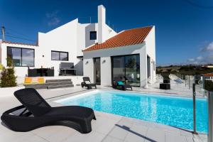 a villa with a swimming pool in front of a house at Casa Tazmin in Santo Isidoro