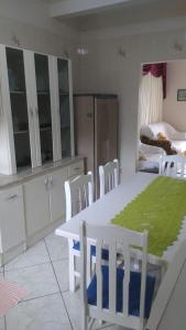 a kitchen with a table and chairs and a bedroom at Casa para aluguel de verão in Torres