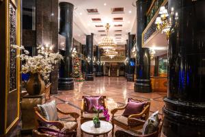 a lobby with chairs and a table and a chandelier at Century Pines Resort Cameron Highlands in Cameron Highlands