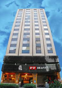 a tall building with a restaurant in front of it at Hotel PF in Mexico City