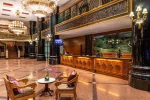 a lobby with a table and chairs in a building at Century Pines Resort Cameron Highlands in Cameron Highlands