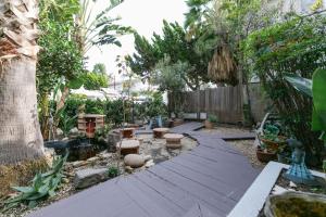 a garden with a wooden floor and trees and a fence at Culver city ·4045 Jackson in Los Angeles
