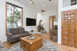 a living room with a couch and a tv at Culver city ·4045 Jackson in Los Angeles